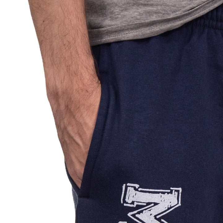 Up close image of hand in deep pocket of Toronto Maple Leafs Navy Fleece Sweatpants.
