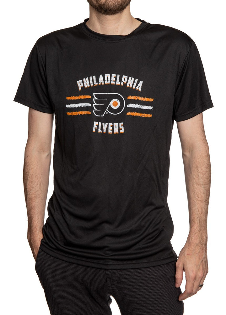 Men's Officially Licensed NHL Distressed Lines Short Sleeve Performance Rashguard Wicking T-Shirt- Philadelphia Flyers  Full Length Front View Of Man Wearing Shirt WIth Hand In Pocket