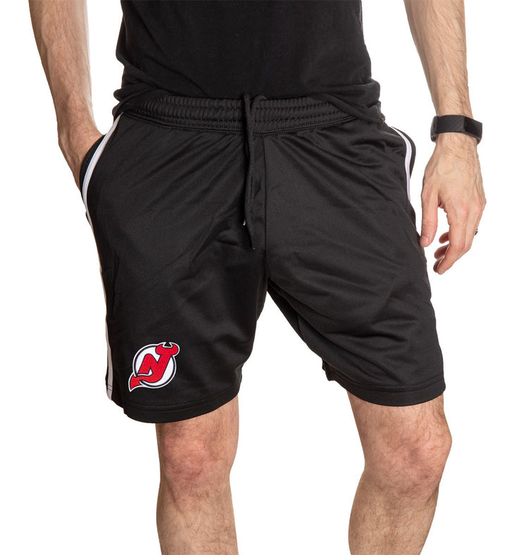NHL Mens Official Team Two-Stripe Shorts- New Jersey Devils Full Front View WIth Mans Hand In Pocket