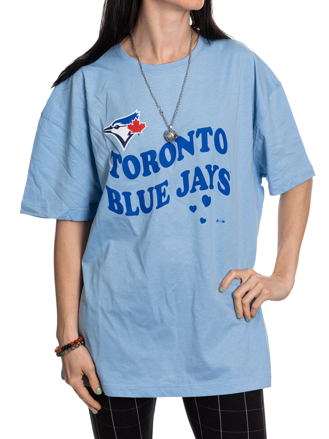 Person wearing a light blue 'Toronto Blue Jays' oversized t-shirt on a white background