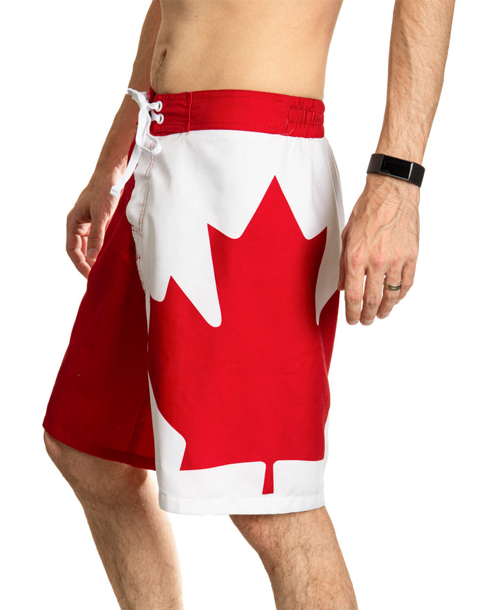 Red and White Canada Boardshort Swim Trunks. Side View. Maple Leaf Down Leg.