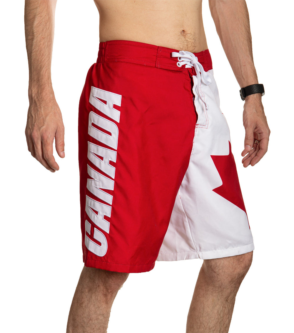 Red and White Canada Boardshort Swim Trunks. Side View., CANADA Written Down Leg.