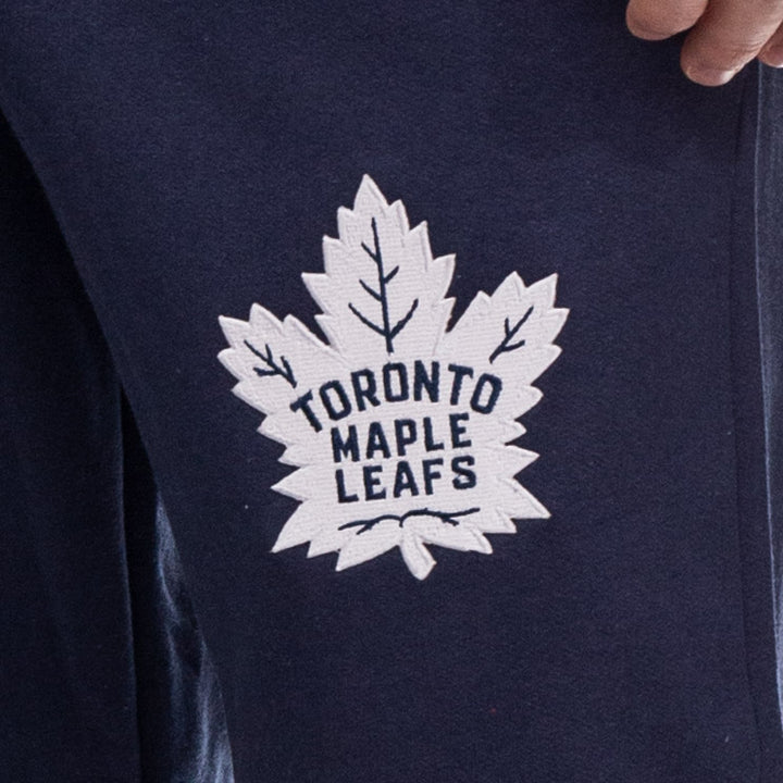 Up close image of embroidered Leafs logo on pant leg. 