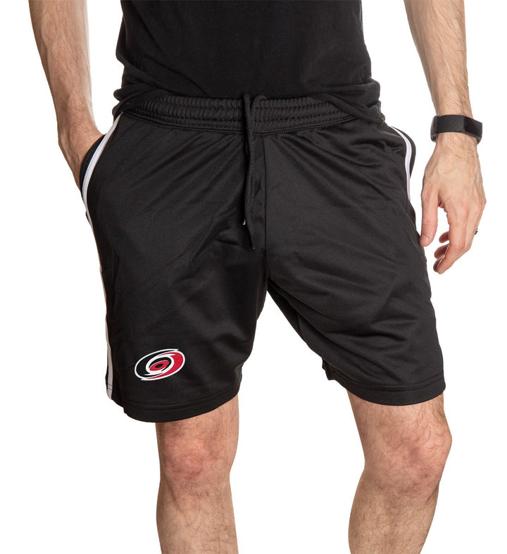 NHL Mens Official Team Two-Stripe Shorts- Carolina Hurricanes Full Front View Of Short With Mans Hand in Pocket