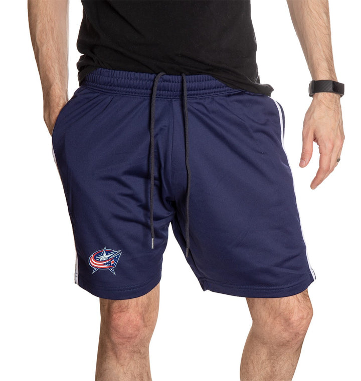 NHL Mens Official Team Two-Stripe Shorts- Columbus Blue Jackets Full Front View With Man Hand In Pocket 